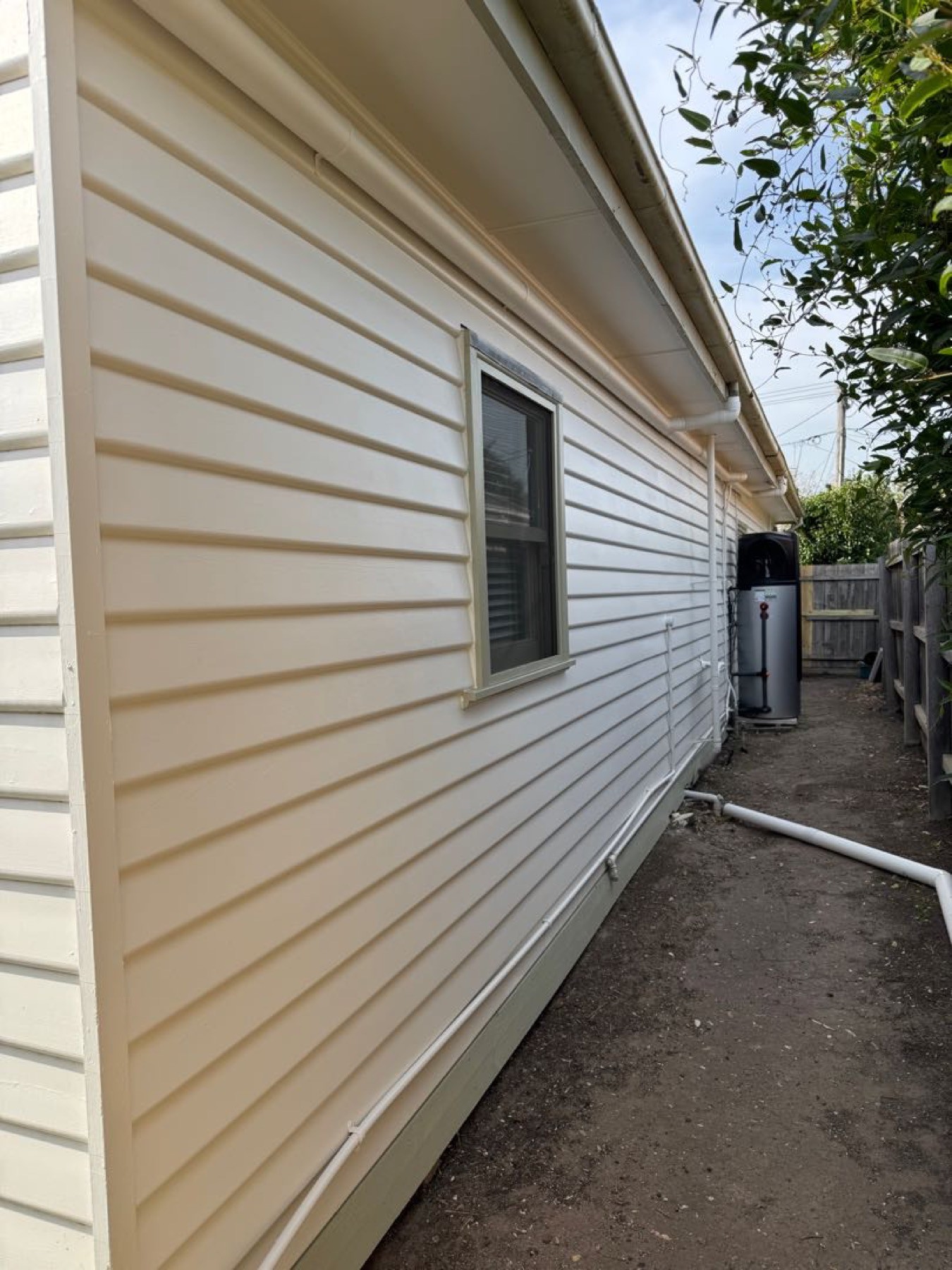 Weatherboard wall and window along the side of a house