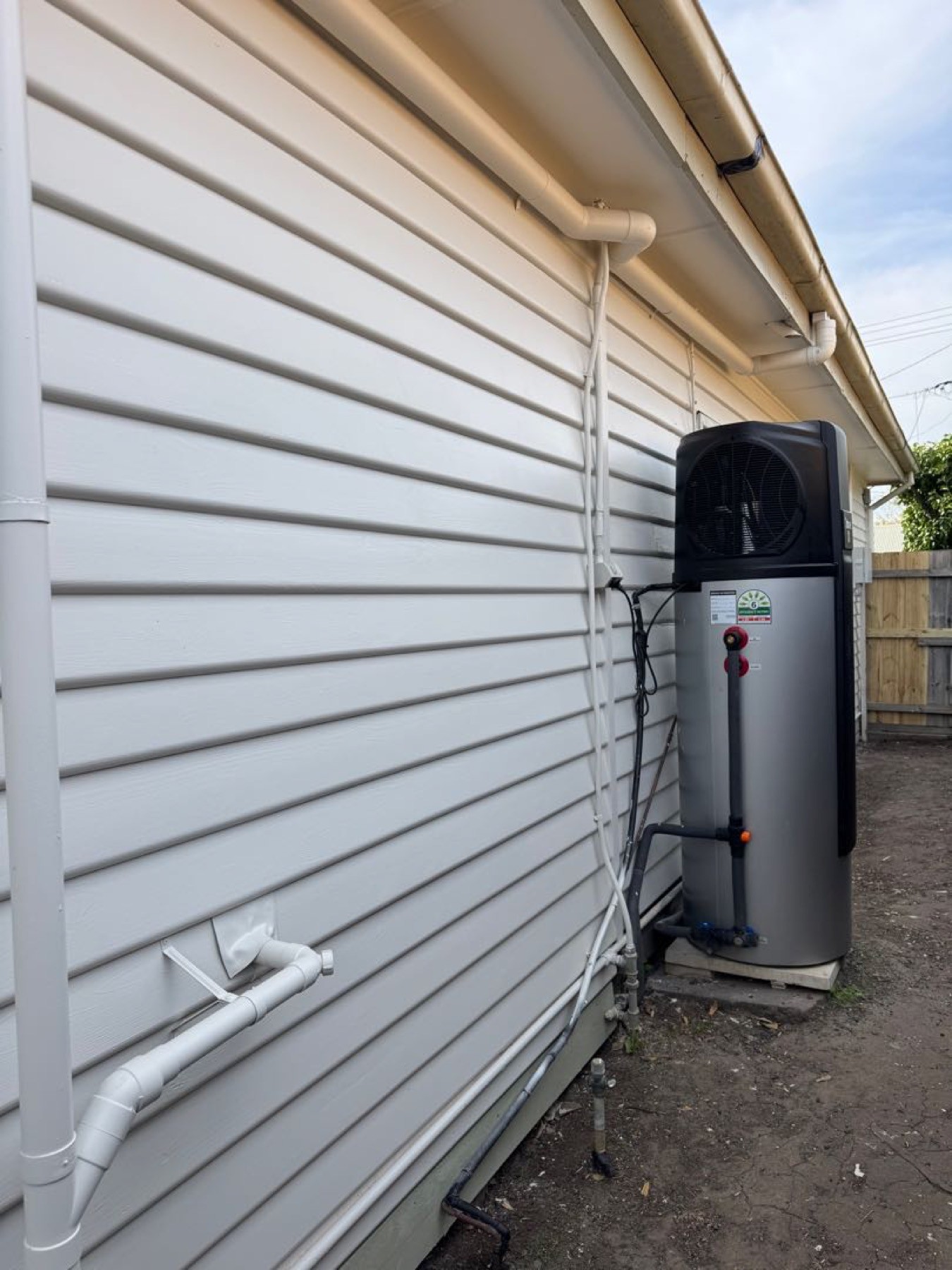 Weatherboard finish around exterior plumbing